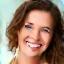 Portrait of Sarah L., 42, smiling confidently.